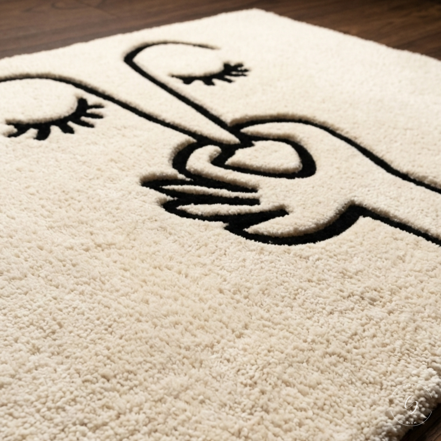 A close-up of a cream-coloured hand tufted bathroom entrance rug featuring a black embroidered design of a hand holding a heart-shaped finger, with eyelashes on the fingers.