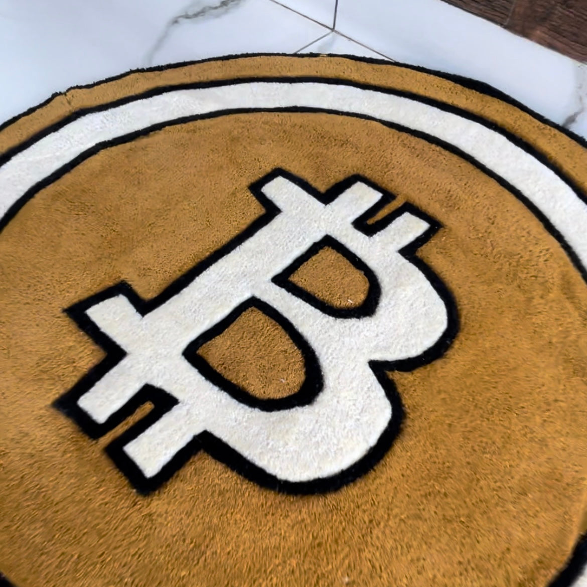 closeup of Bitcoin cryptocurrency hand tufted rug in signature orange and white colourway