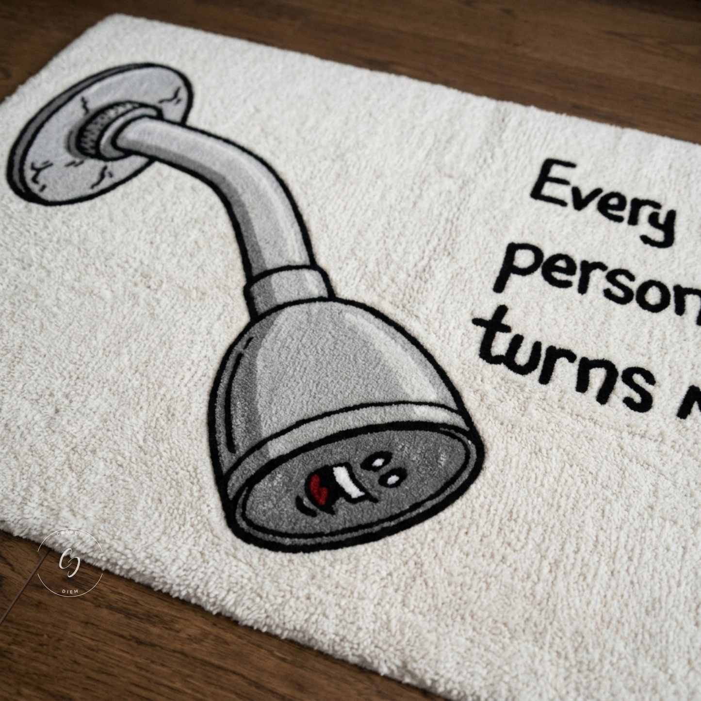 A white textured hand tufted rug featuring a cartoon shower head illustration and the humorous text laid out on a dark wood floor.