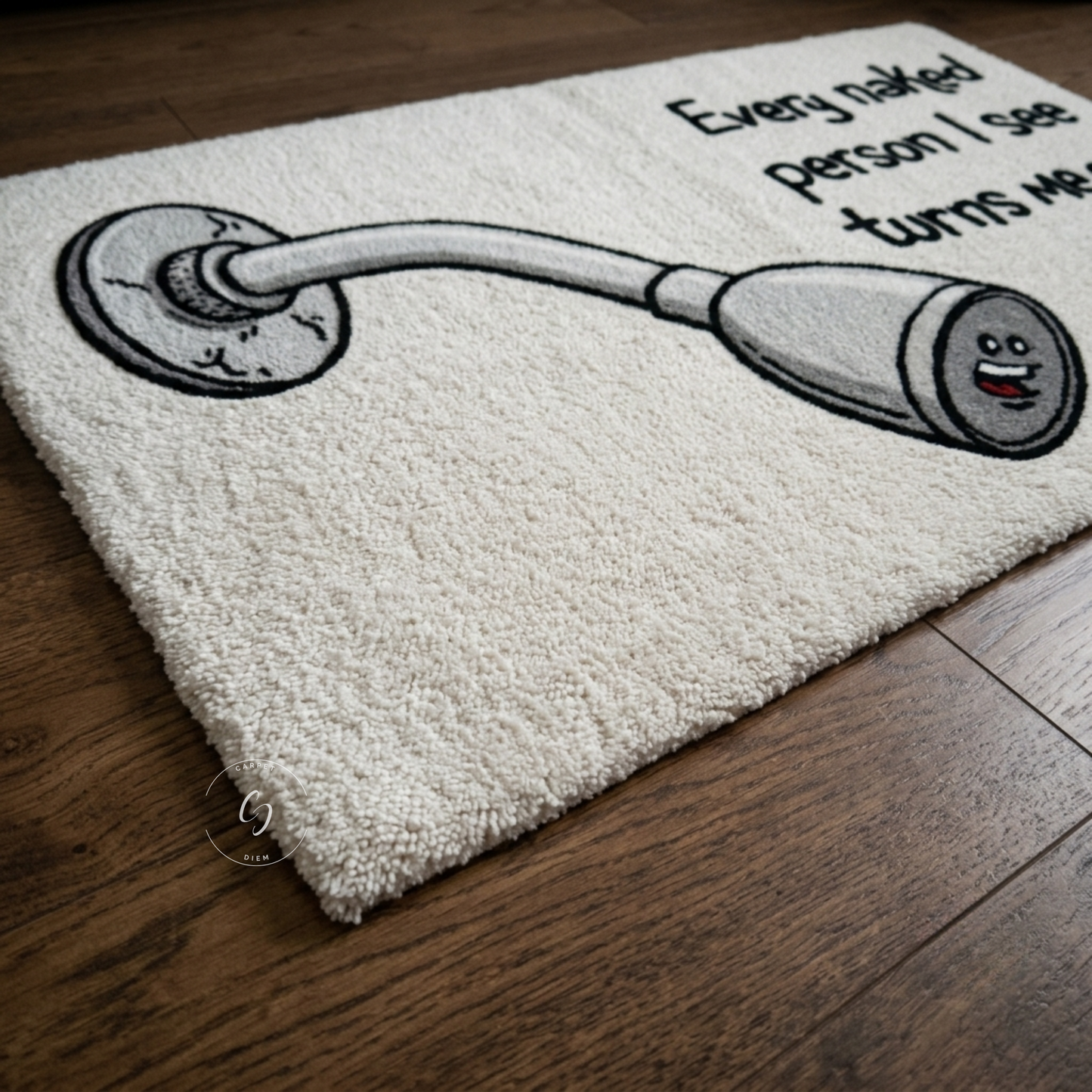 A textured cream-colored hand tufted rug with a humorous cartoon graphic of a faucet with a face and the text 'Every naked person I see turns me on', displayed on a dark wood floor.