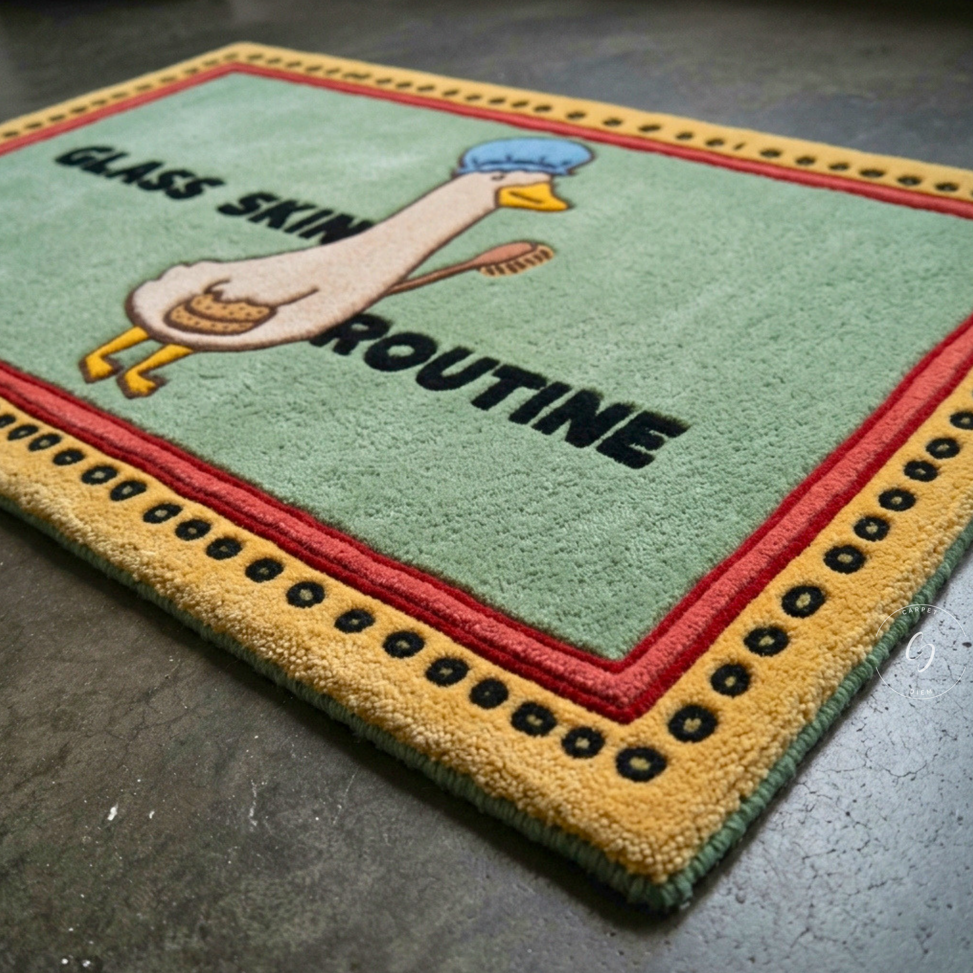 A rectangular hand tufted bathroom entrance rug with a cartoon duck wearing a blue beanie and holding a glass, with the words 'GLASS SKIN ROUTINE' 