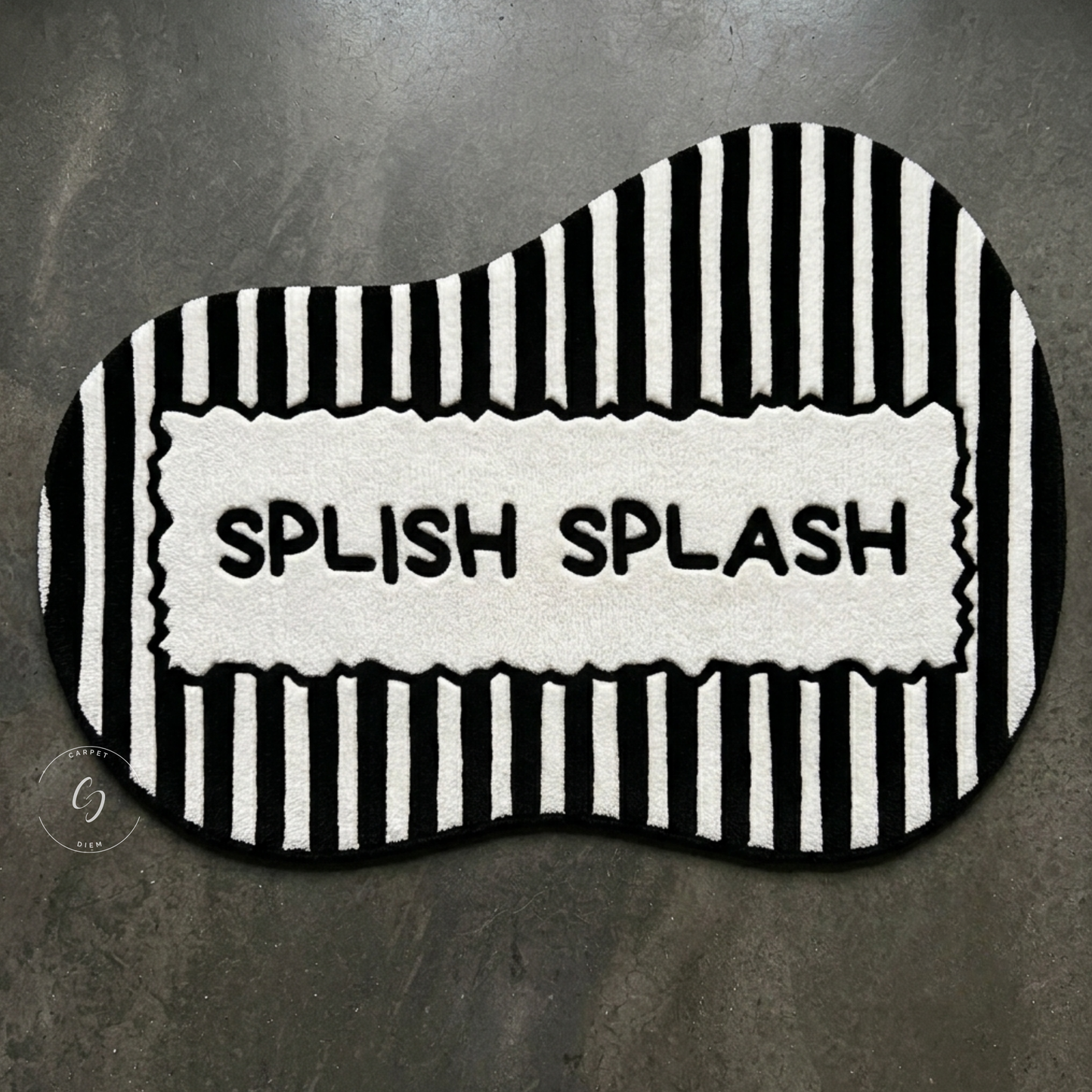 A black and white wavy hand tufted bathroom entrance rug with vertical stripes and a central white panel reading 'SPLISH SPLASH' in black letters.