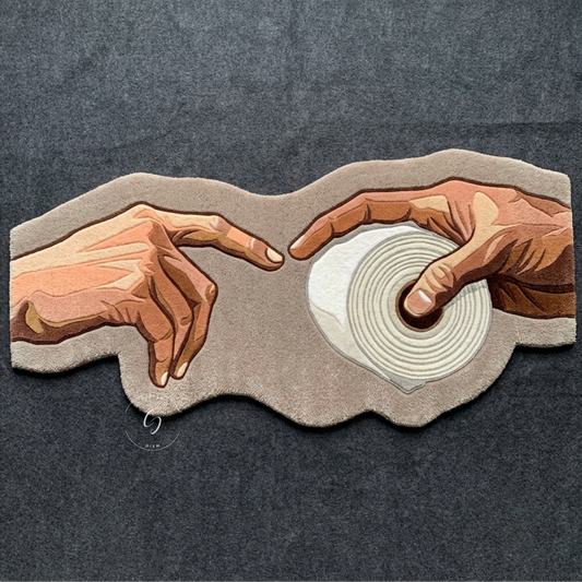 Need TP? hand-tufted New Zealand wool bathroom entrance rug shaped like two hands reaching for a toilet paper roll, a playful spin on a classic painting.