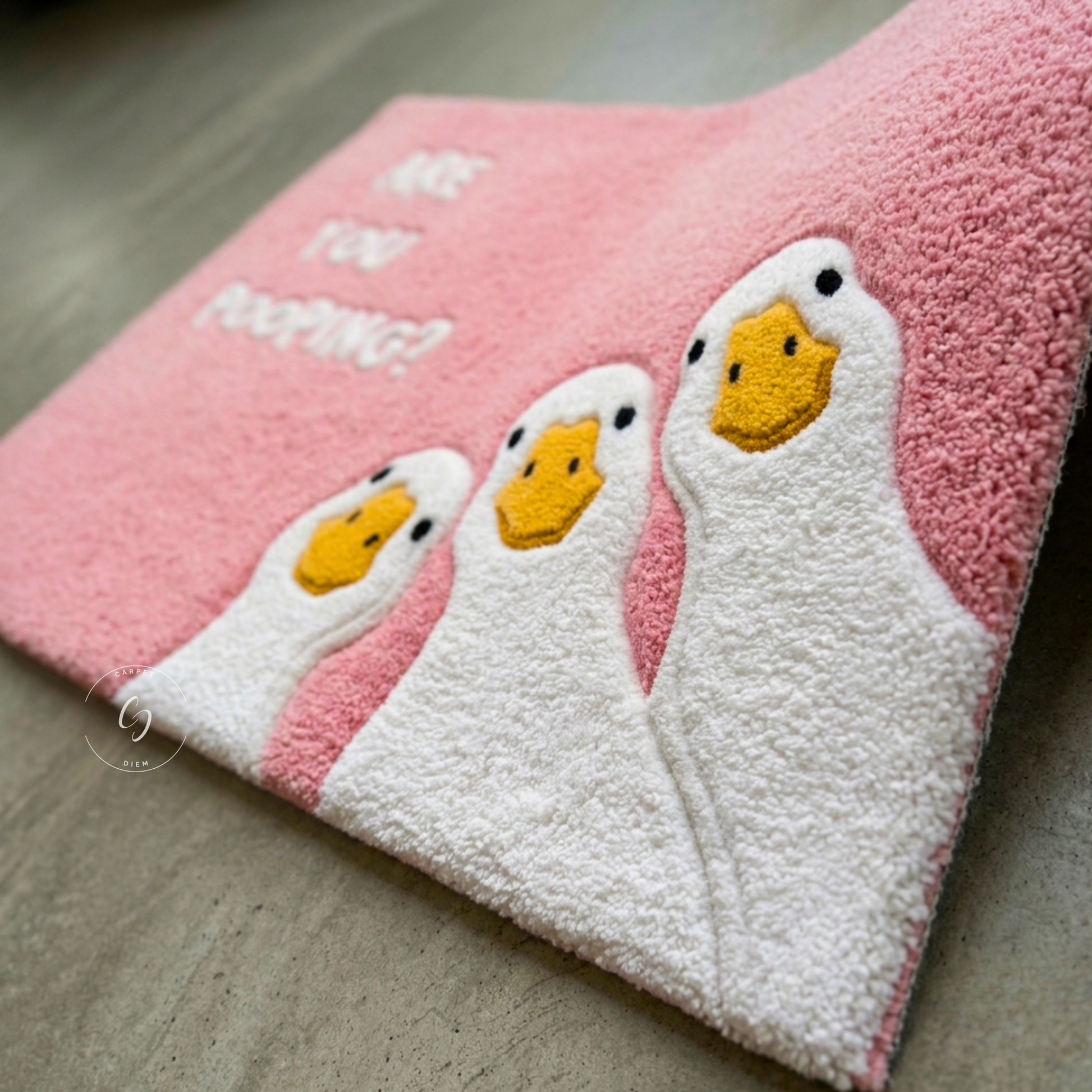 A pink textured hand tufted bathroom entrance rug featuring three white ducks with yellow beaks and the text 'ARE YOU POOPING?' in white, shown on a grey floor.