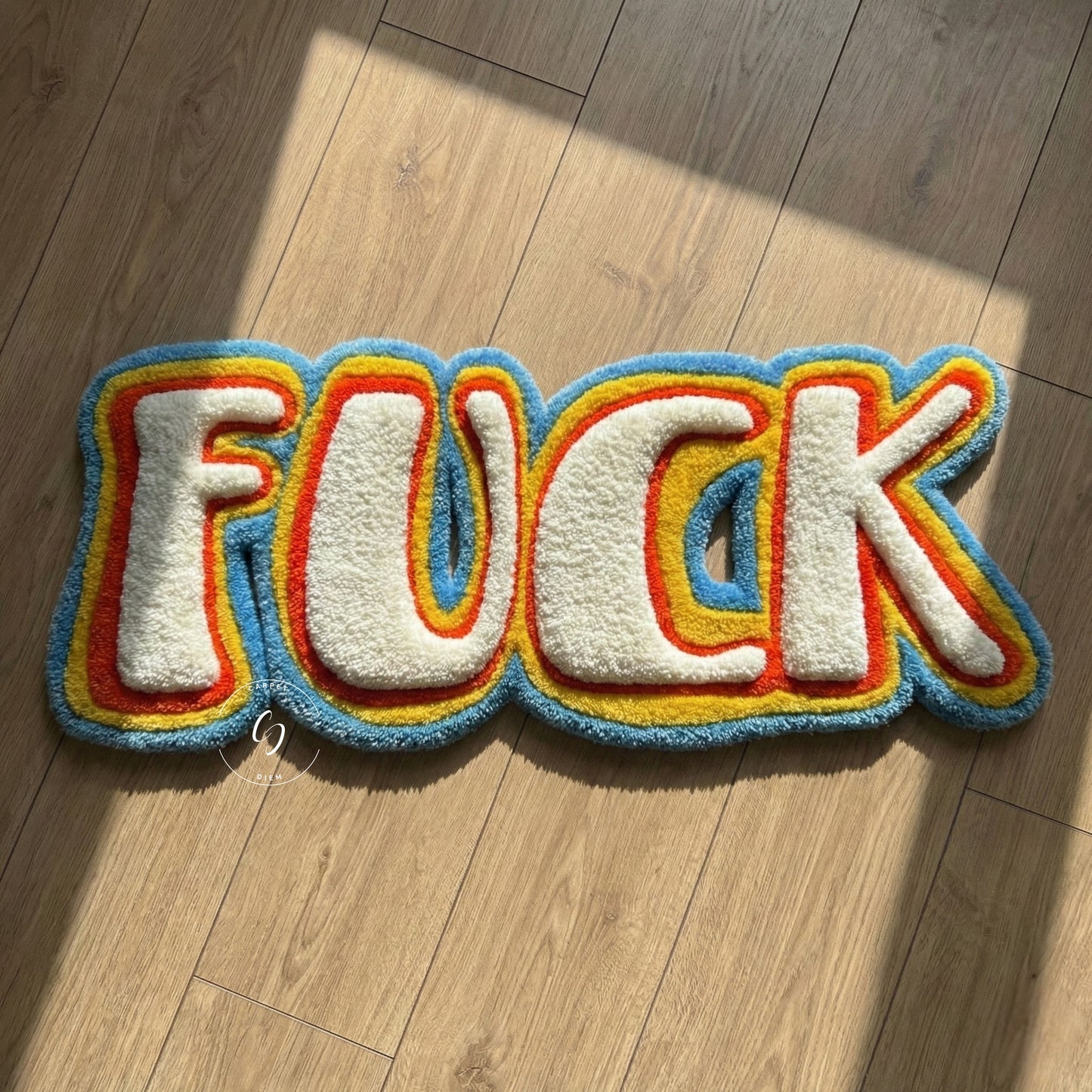 Colourful rug with the word 'FUCK' tufted