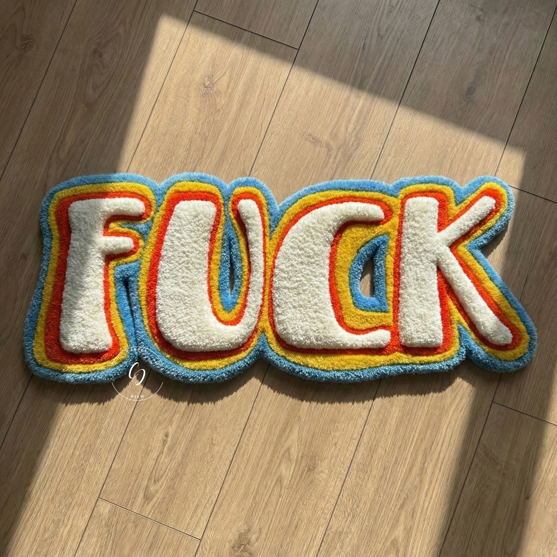 Colourful rug with the word 'FUCK' tufted