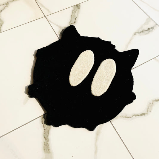 Black cat rug with big white eyes