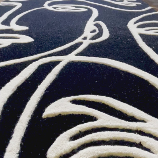 close up video of Abstract Faces Hand-Tufted Rug